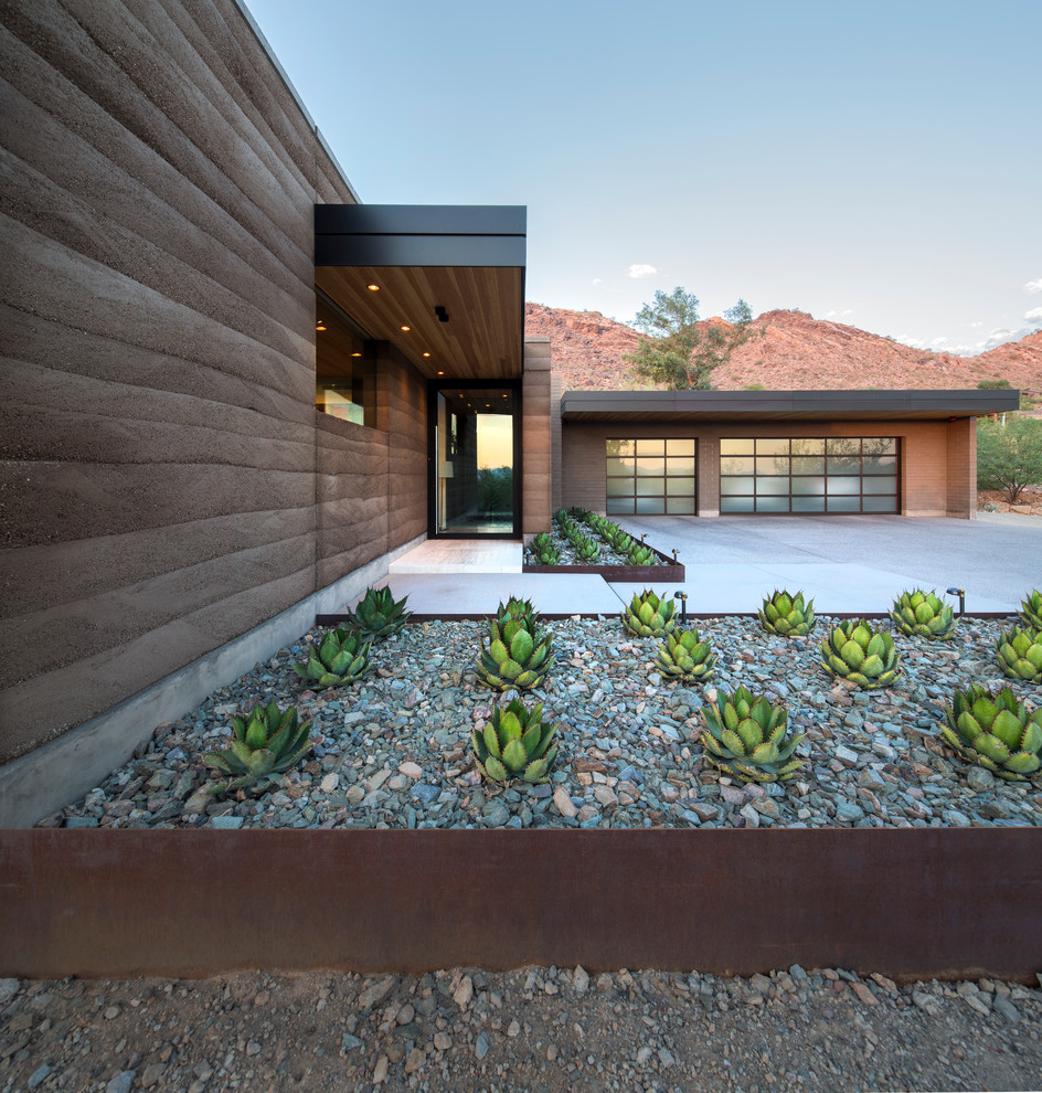 This is an example of a contemporary entrance in Phoenix with a single front door and a glass front door.