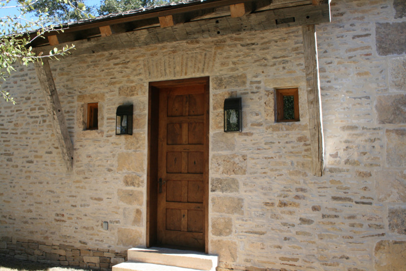 Mountain style entryway photo in Austin with a brown front door