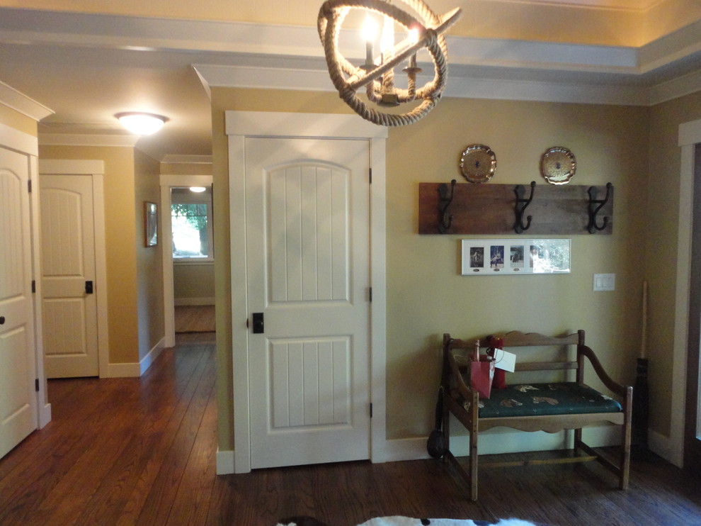 Example of a mountain style medium tone wood floor entryway design in San Francisco with beige walls and a medium wood front door