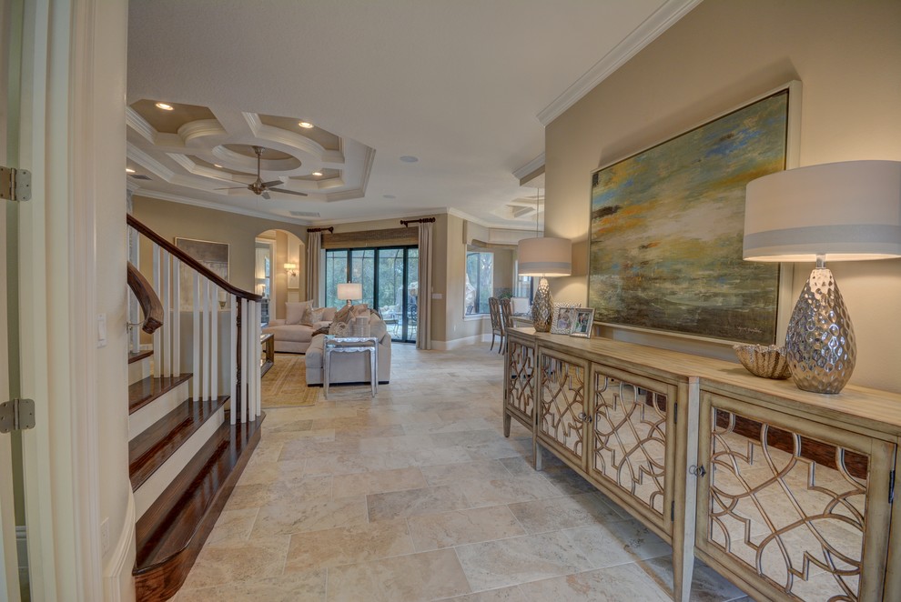 Inspiration for a large transitional travertine floor and beige floor entryway remodel in Orlando with beige walls