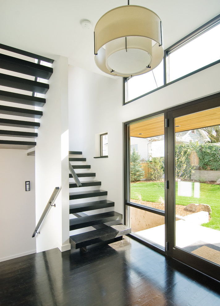 This is an example of a contemporary entrance in Seattle with white walls.