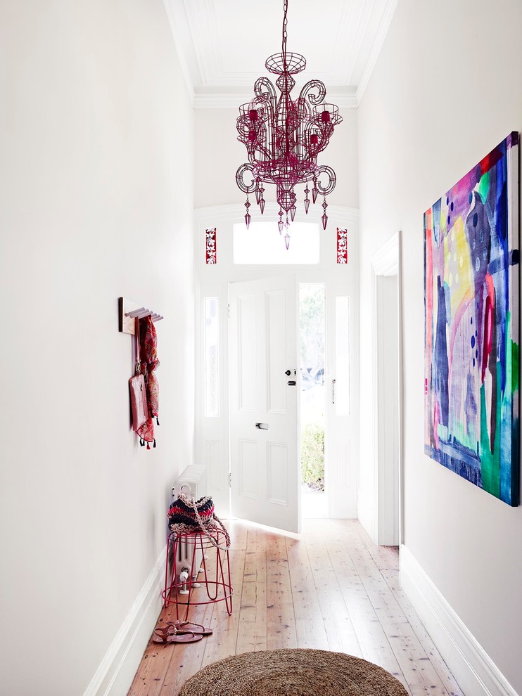 Inspiration for a contemporary light wood floor entryway remodel in Melbourne with white walls and a white front door