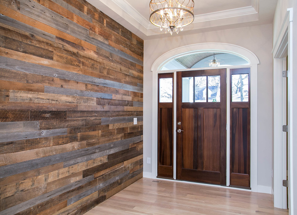Design ideas for a traditional front door in Minneapolis with grey walls, light hardwood flooring, a single front door and a medium wood front door.