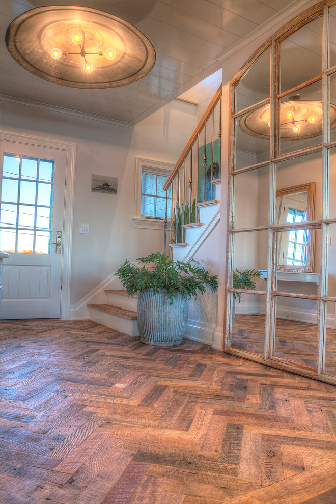 Entryway - mid-sized traditional dark wood floor and brown floor entryway idea in New York with beige walls and a white front door