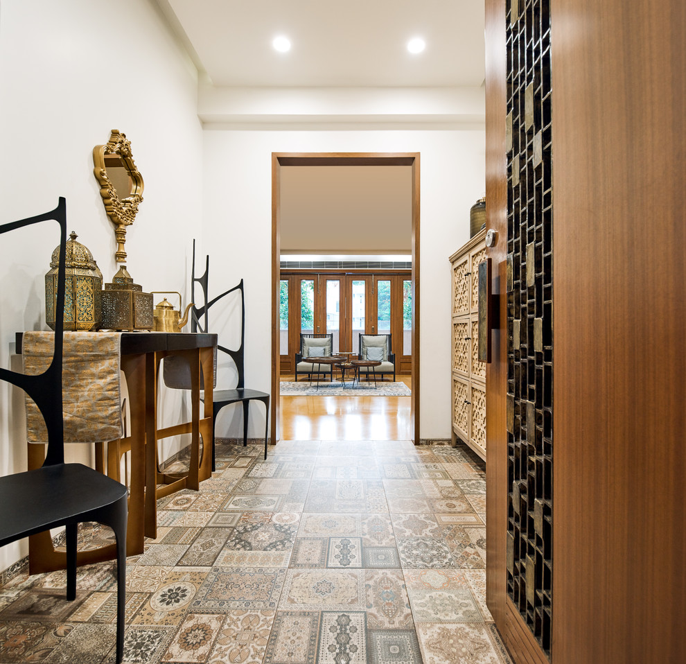 Tuscan carpeted and multicolored floor entry hall photo in Bengaluru with white walls
