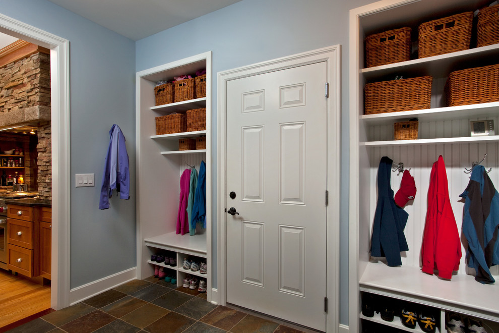 This is an example of a large classic boot room in Boston with ceramic flooring, a single front door and a white front door.