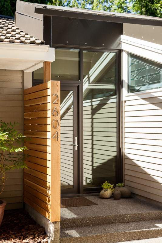 Photo of a contemporary front door in Seattle with a single front door and a glass front door.