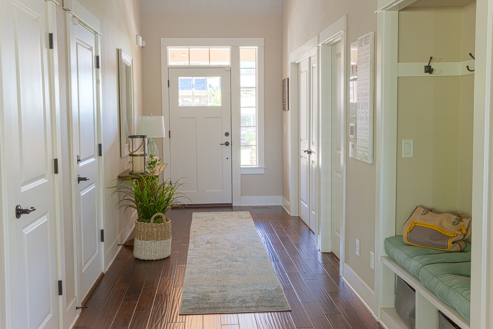 Design ideas for a large beach style entrance in Portland with beige walls, dark hardwood flooring, a single front door and a white front door.