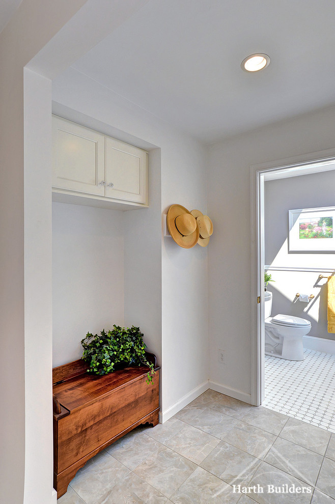 This is an example of a medium sized classic boot room in Philadelphia with grey walls, porcelain flooring, a single front door and a white front door.
