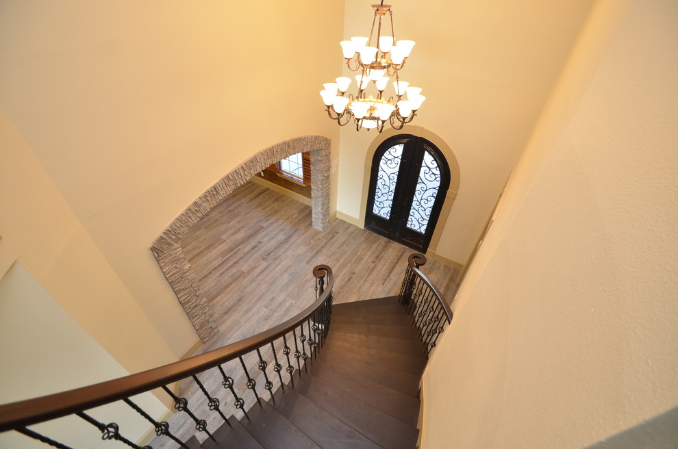 This is an example of a large traditional foyer in Houston with a double front door and a black front door.