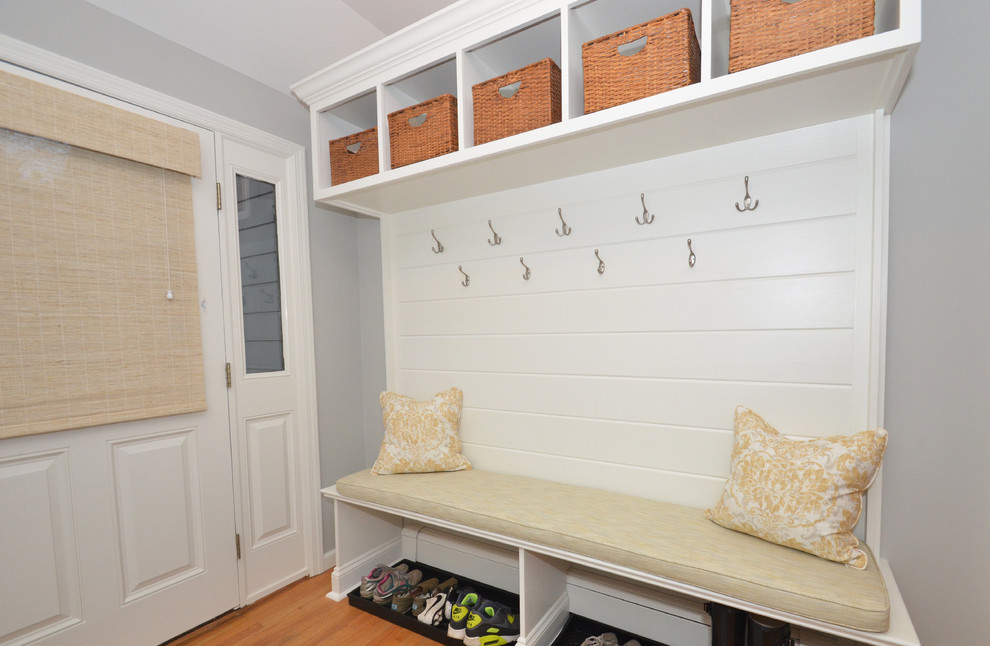 Photo of a medium sized traditional boot room in New York with grey walls, light hardwood flooring, a single front door and a white front door.