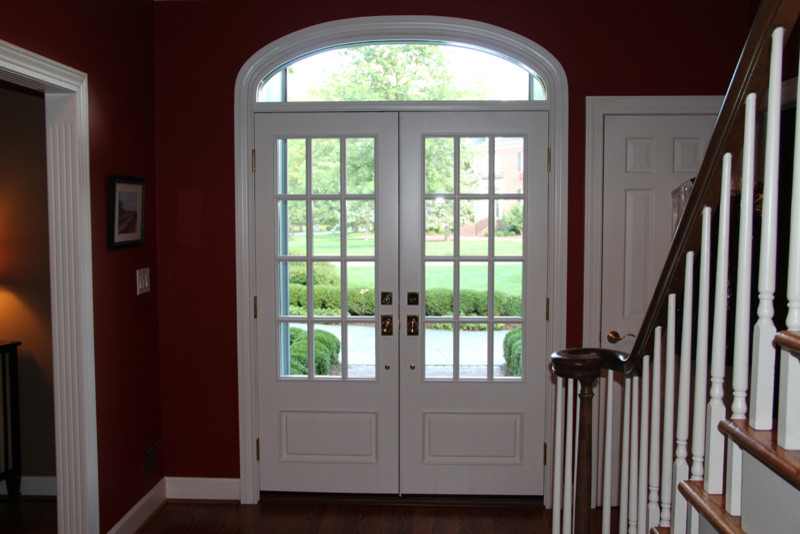 На фото: входная дверь в классическом стиле с фиолетовыми стенами, двустворчатой входной дверью и белой входной дверью