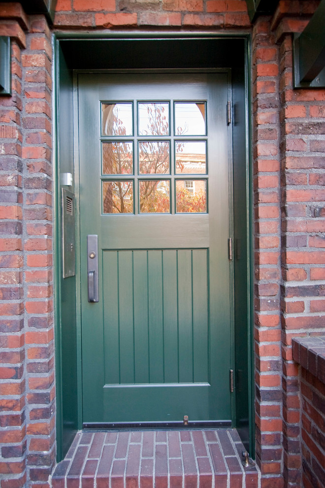 Entryway - traditional entryway idea in Portland with a green front door