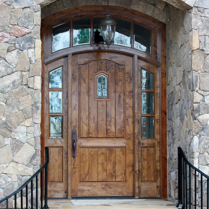 Inspiration for a rustic front door remodel in Austin with a light wood front door