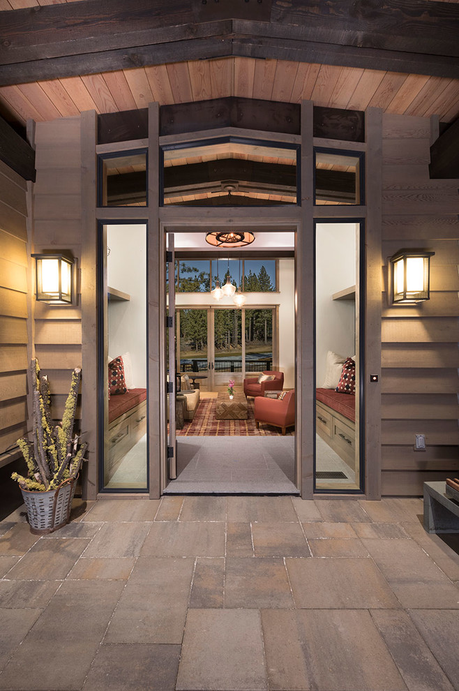 This is an example of a large rustic front door in Other with beige walls, slate flooring, a single front door, a medium wood front door and grey floors.