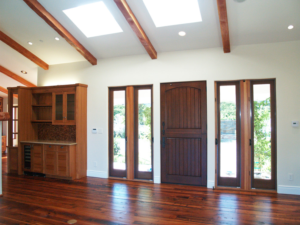 This is an example of a large classic front door in Los Angeles with white walls, medium hardwood flooring, a stable front door and a dark wood front door.