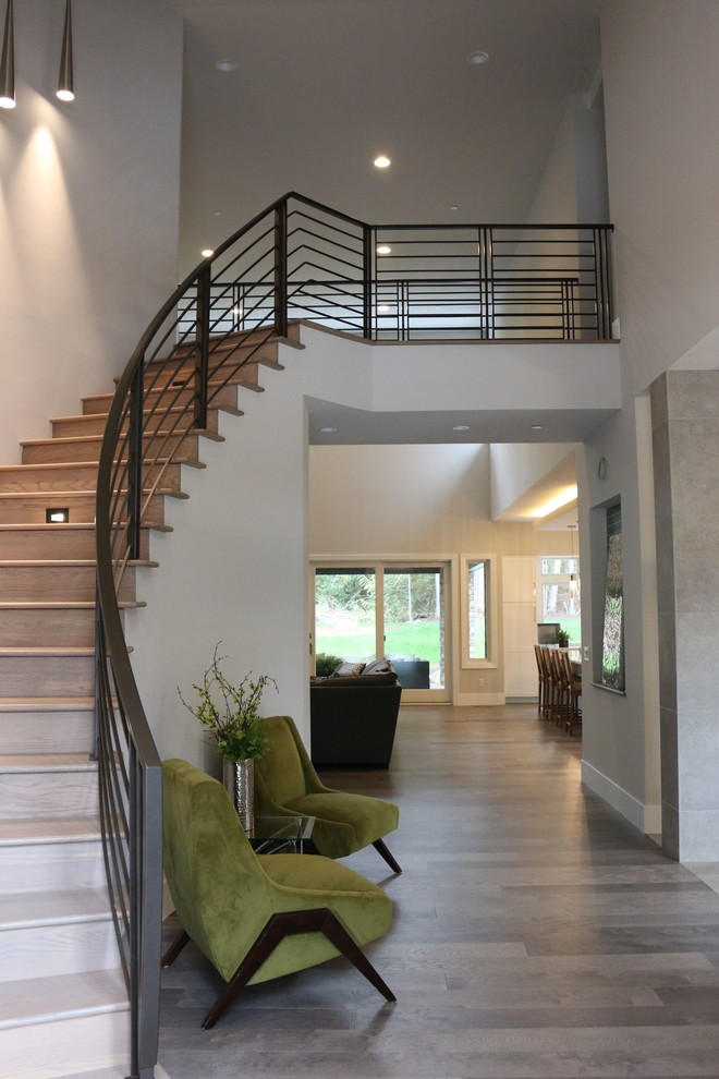 Photo of a medium sized modern foyer in Seattle with beige walls, porcelain flooring, a double front door, a black front door and grey floors.