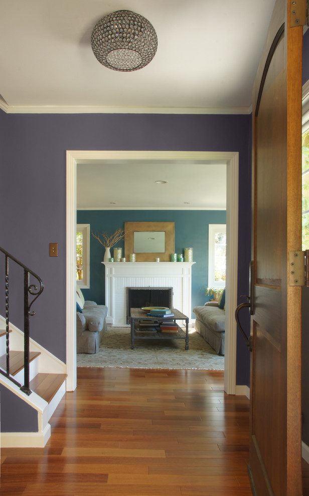На фото: прихожая в стиле кантри с фиолетовыми стенами, паркетным полом среднего тона, одностворчатой входной дверью и входной дверью из темного дерева