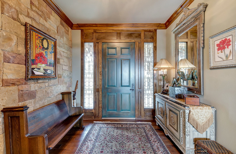 Inspiration for a mid-sized mediterranean dark wood floor and brown floor entryway remodel in Dallas with beige walls and a blue front door