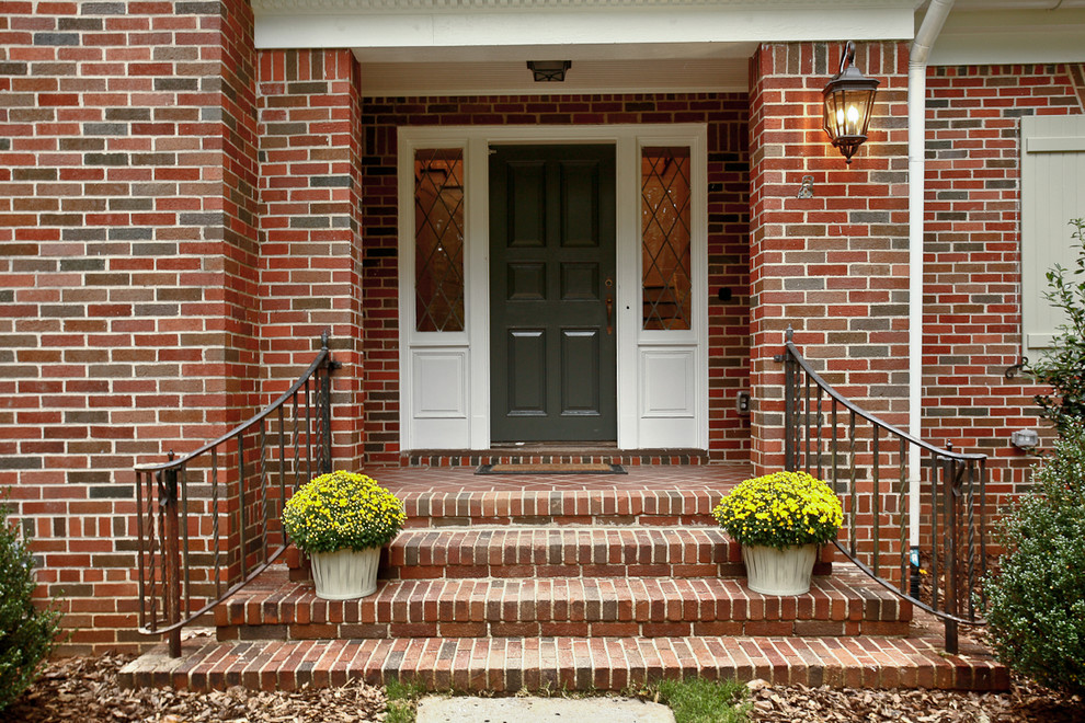 Inspiration for a timeless brick floor entryway remodel in Atlanta with a gray front door