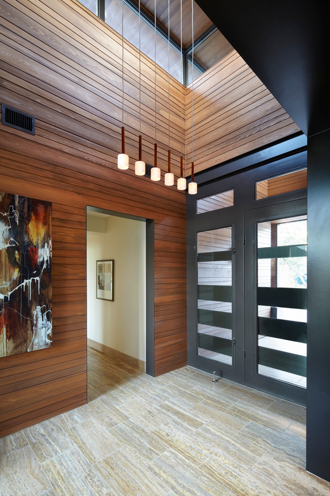 Inspiration for a contemporary entrance in Austin with a glass front door.