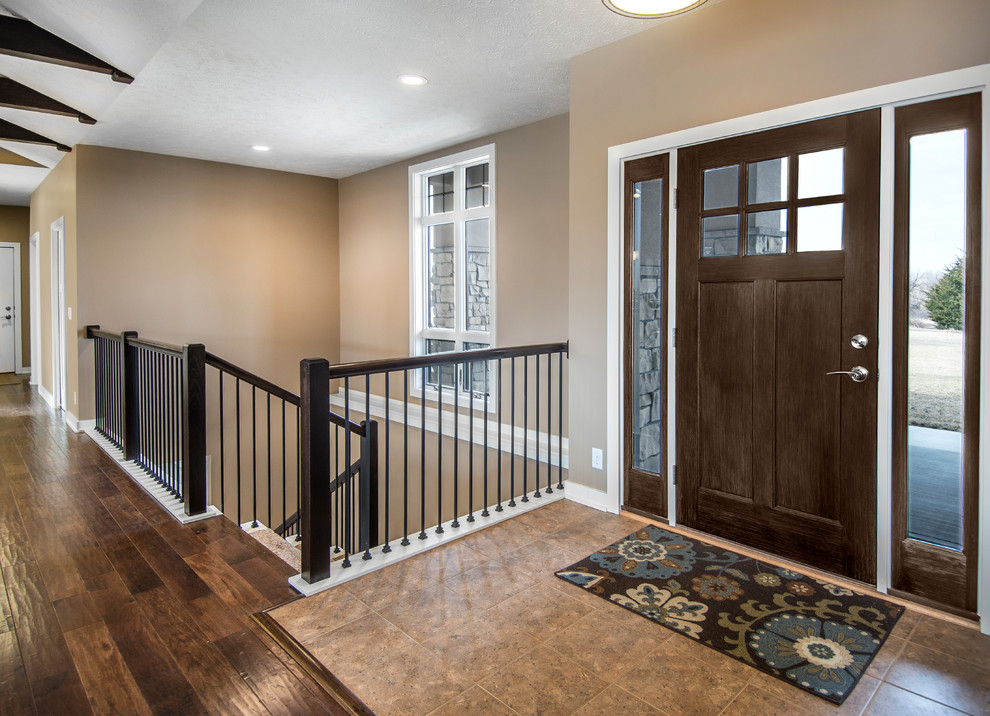 Inspiration for a craftsman entryway remodel in Omaha with beige walls and a dark wood front door