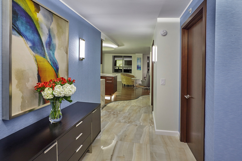 Example of a large trendy porcelain tile entryway design in Chicago with blue walls and a dark wood front door