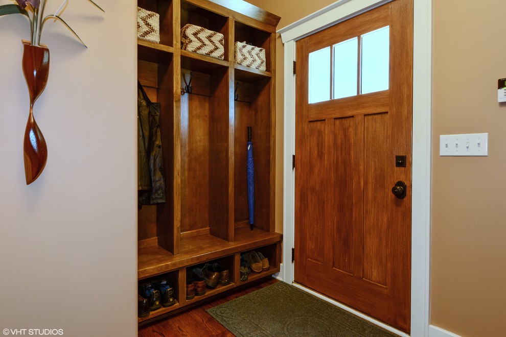 Inspiration for a mid-sized craftsman dark wood floor entryway remodel in Chicago with beige walls and a medium wood front door
