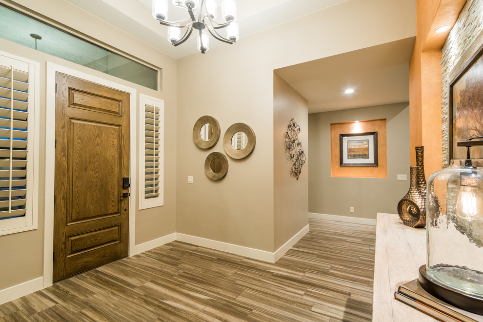 Example of a mid-sized transitional porcelain tile entryway design in Salt Lake City with beige walls and a medium wood front door