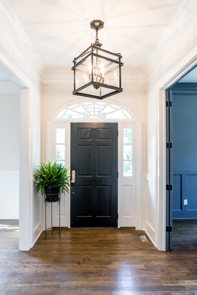 Идея дизайна: входная дверь среднего размера в классическом стиле с белыми стенами, кирпичным полом, одностворчатой входной дверью, черной входной дверью и коричневым полом