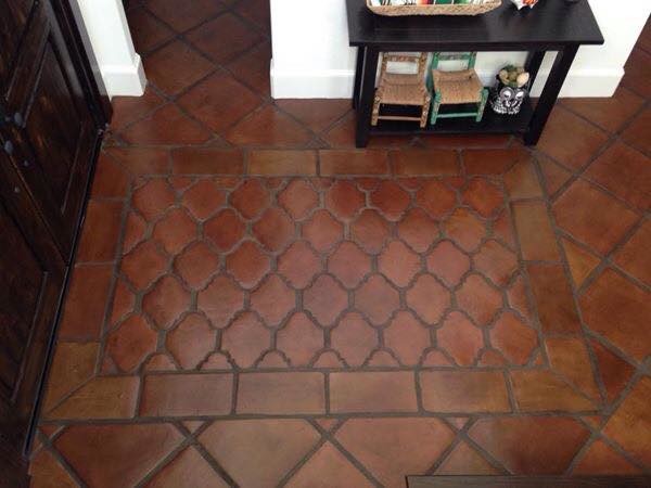 Inspiration for a large mediterranean terra-cotta tile and orange floor entryway remodel in Houston with beige walls and a dark wood front door
