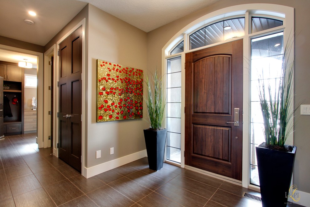 Entryway - large transitional porcelain tile entryway idea in Calgary with gray walls and a dark wood front door