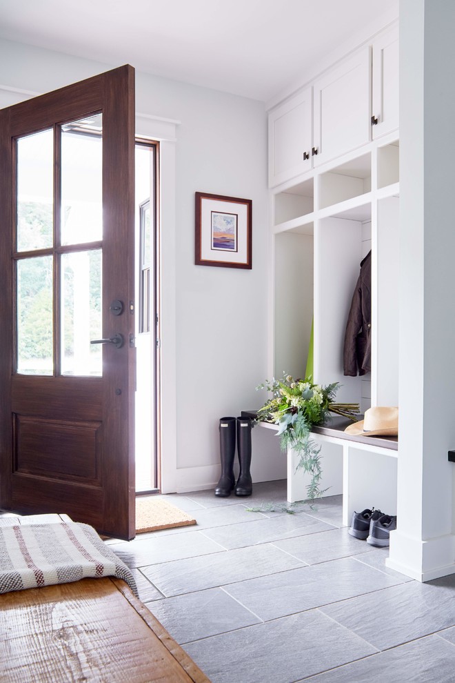 Idées déco pour une entrée campagne de taille moyenne avec un vestiaire, un mur blanc, une porte simple, une porte en bois foncé, un sol gris et un sol en carrelage de porcelaine.