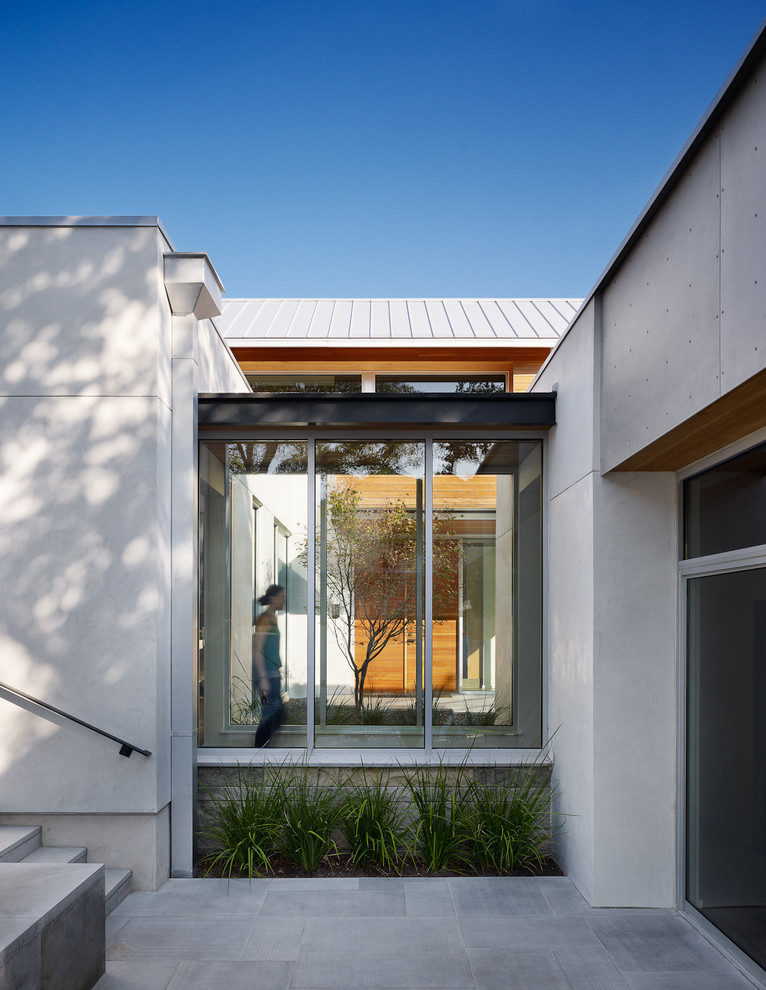 Trendy entryway photo in Austin with a glass front door