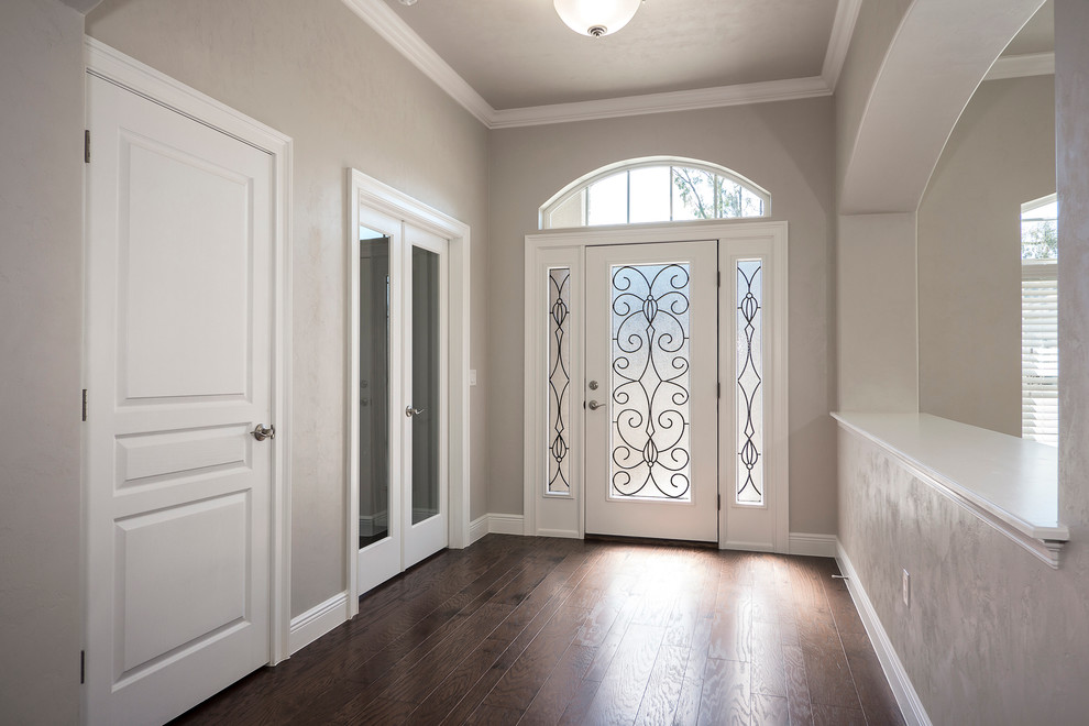 Design ideas for a medium sized traditional foyer in Miami with beige walls, dark hardwood flooring, a single front door and a white front door.