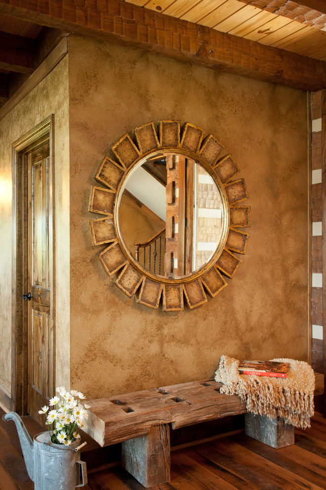 This is an example of a medium sized rustic foyer in Other with beige walls and medium hardwood flooring.