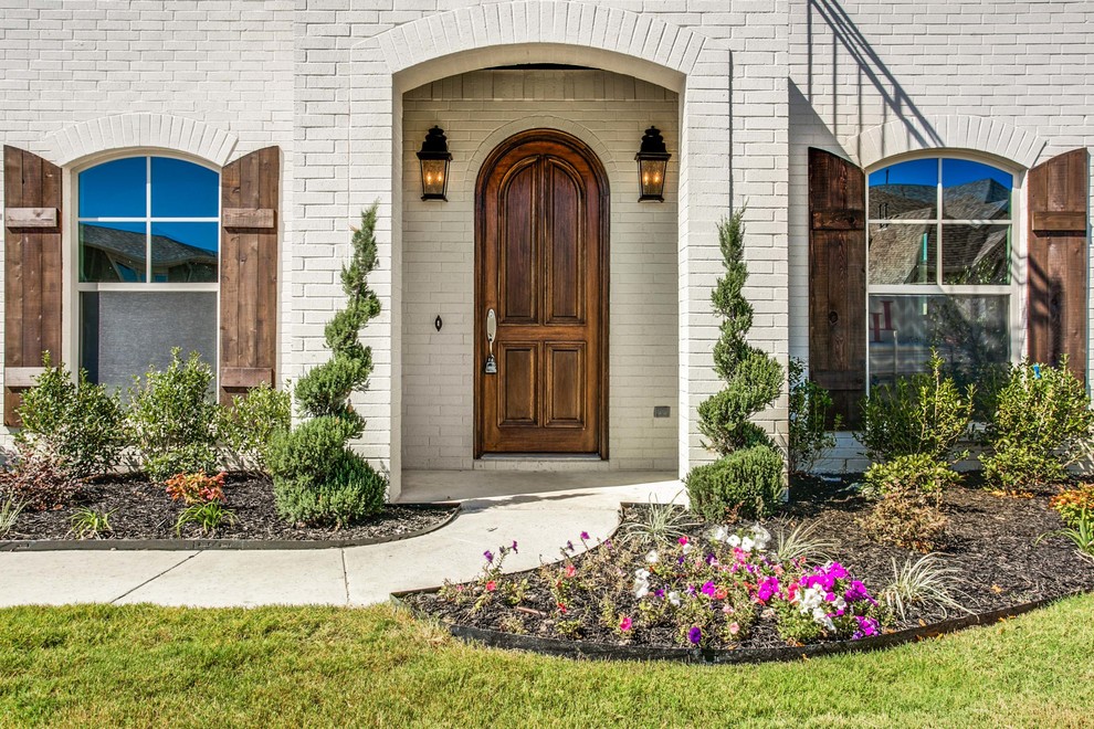 This is an example of a traditional front door in Dallas with a single front door and a dark wood front door.