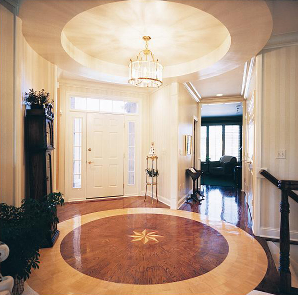Inspiration for a traditional foyer with white walls, medium hardwood flooring, a single front door and a white front door.