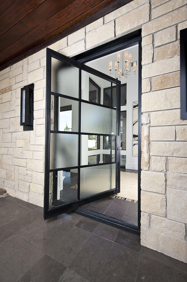 На фото: прихожая в современном стиле с поворотной входной дверью и стеклянной входной дверью