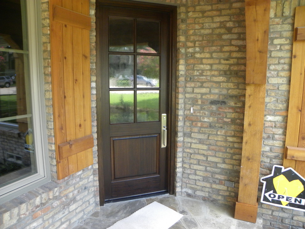 Design ideas for a traditional front door in Dallas with beige walls, medium hardwood flooring, a single front door and a medium wood front door.