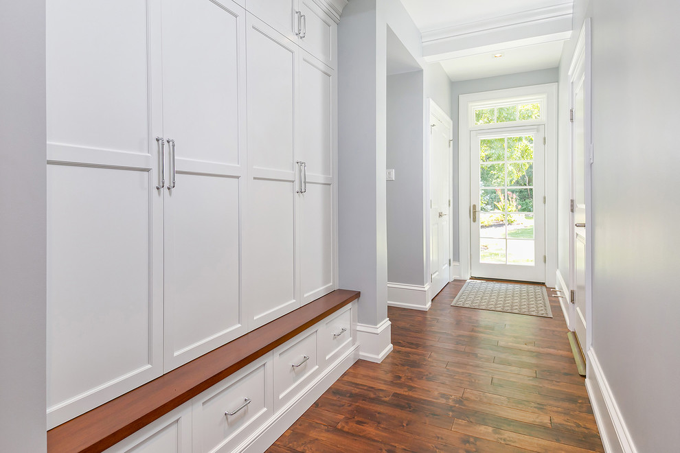 Large transitional dark wood floor and brown floor entryway photo in Philadelphia with gray walls and a white front door