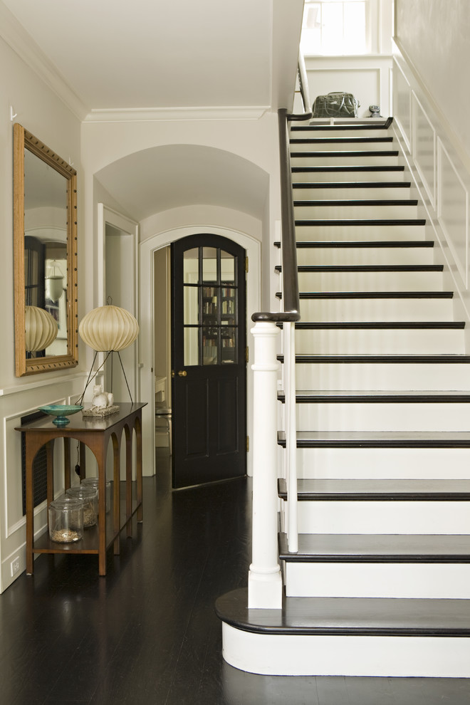 Ornate dark wood floor and black floor entry hall photo in Los Angeles