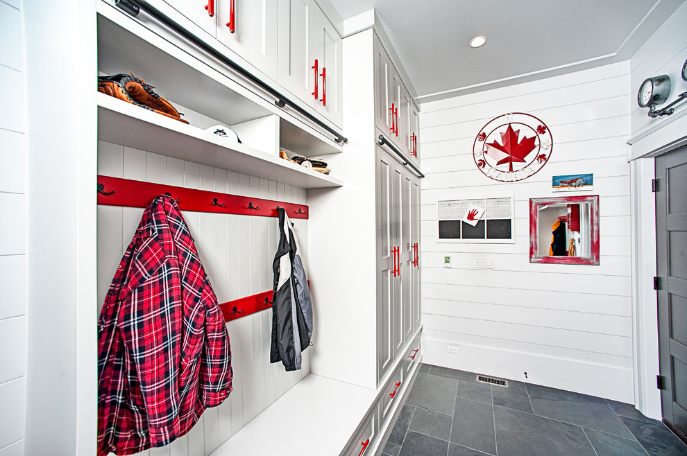 This is an example of a medium sized rustic boot room in Toronto with white walls, ceramic flooring, a single front door, a grey front door and grey floors.