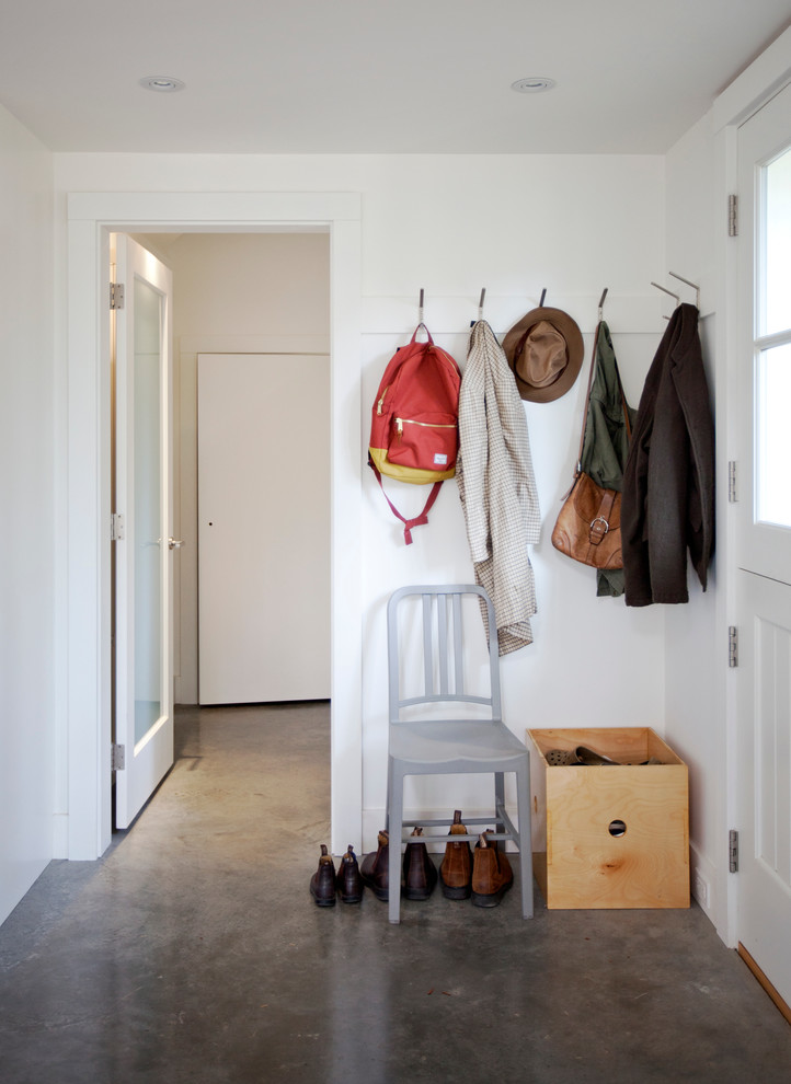 Inspiration for a transitional concrete floor mudroom remodel in Vancouver