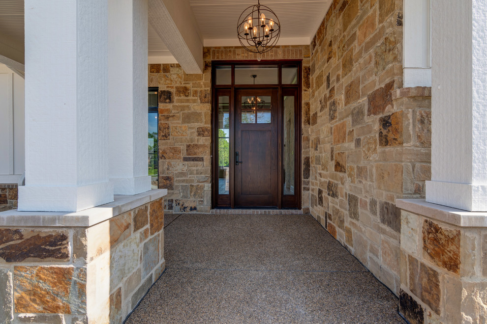 Foto de entrada campestre con paredes beige, suelo de cemento, puerta simple, puerta de madera oscura y suelo marrón