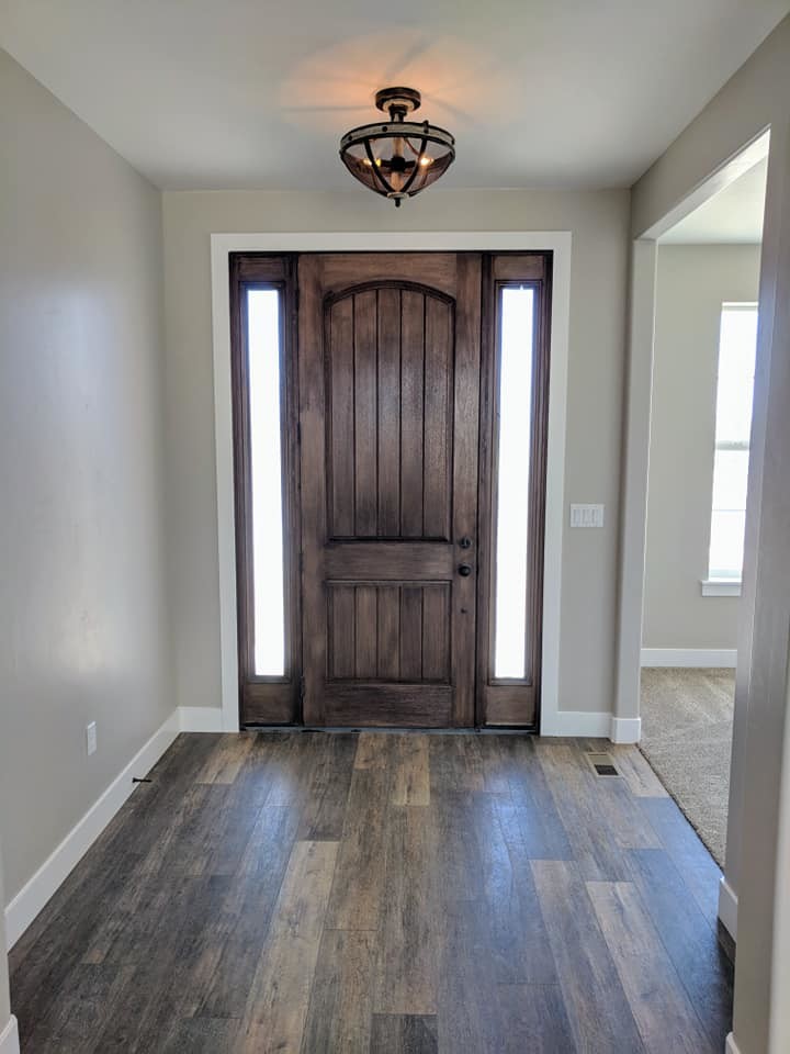 Classic entrance in Salt Lake City with vinyl flooring and brown floors.