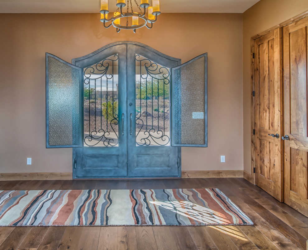 Photo of a large rustic front door in Phoenix with beige walls, medium hardwood flooring, a double front door and a metal front door.