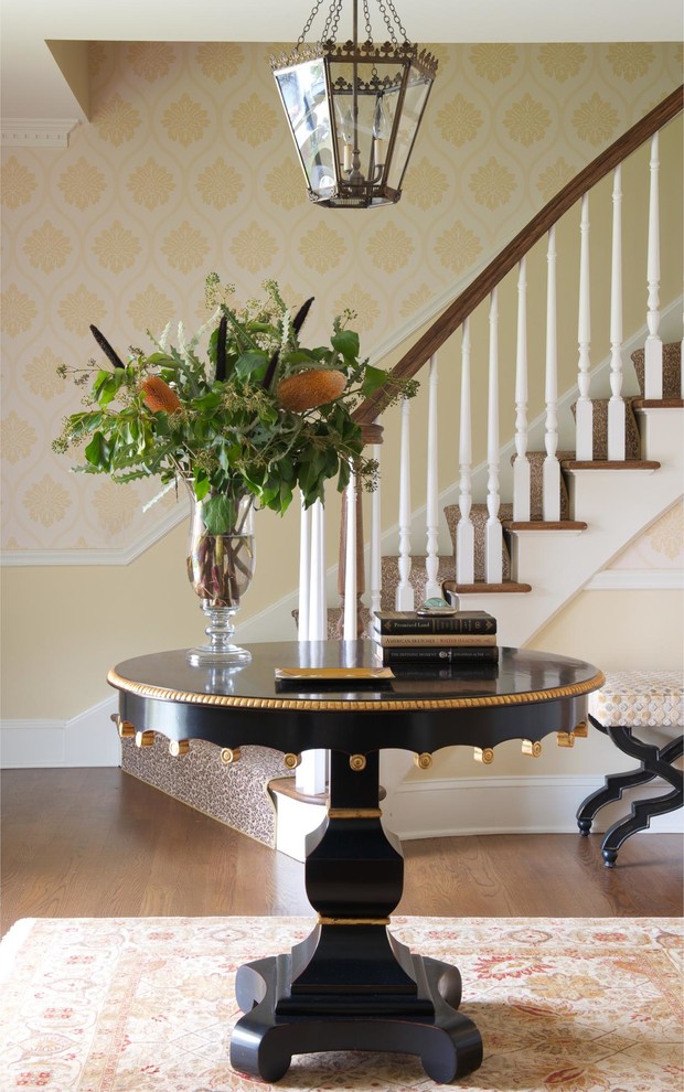 This is an example of a traditional foyer in New York with beige walls and medium hardwood flooring.