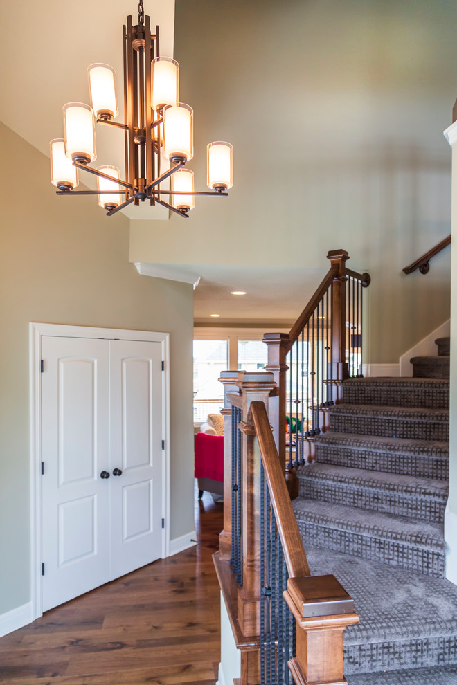 Inspiration for a mid-sized eclectic dark wood floor and brown floor entryway remodel in Kansas City with beige walls and a white front door