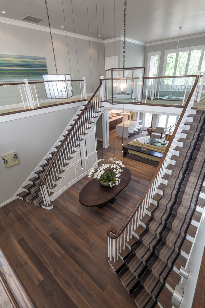 Example of a large trendy dark wood floor foyer design in Sacramento with gray walls